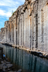 Discover the stunning beauty of Studlagil Canyon in Iceland, where towering basalt columns rise...