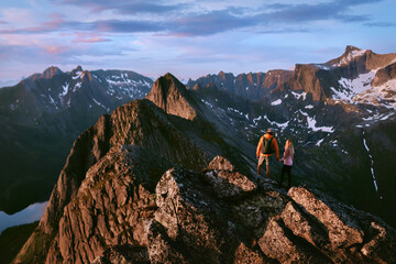 Couple friends travel in Norway climbing mountains together man and woman hiking, summer active...