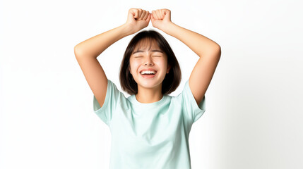 Happy Young Woman Celebrating with Raised Arms Against White Background in Light Mint T-Shirt