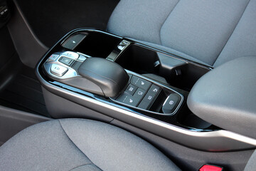 Close up electric car automatic transmission. Central console in interior of electric car. Gear...