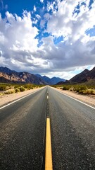 Fototapeta premium Straight empty highway road through desert mountain landscape