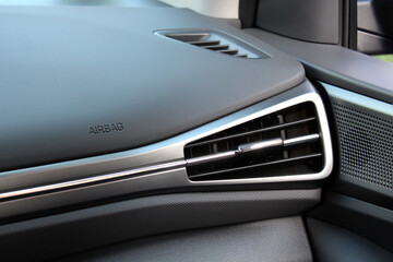 Lux electric car air vents close-up grille. Air ventilation grille with power regulator. Lux electric car air conditioner, interior with front airbag of new premium car. Air ventilation modern vehicle