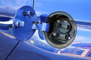 Blue Electric Vehicle Charging Port. Electric vehicle charging port on the rear fender. Electric vehicle charging ports capped. The electric car is ready for charging.