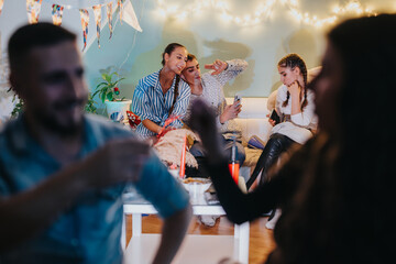 A friendly gathering at home featuring celebration, laughter, and casual moments with lights and...