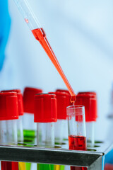 A scientist in a modern laboratory analyzes a blood sample using advanced biotechnology and...