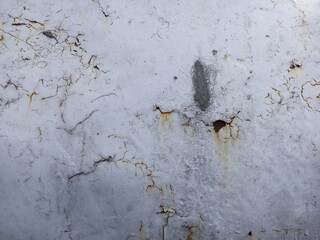 Cracked White Paint on a Rusted Metal Surface