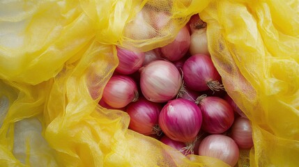 Fresh red onions in bright yellow netting, close-up of harvest storage concept