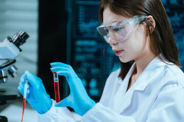 A scientist in a modern laboratory analyzes a blood sample using advanced biotechnology and equipment, conducting medical research for diagnostics, innovation, discovery, and healthcare development.