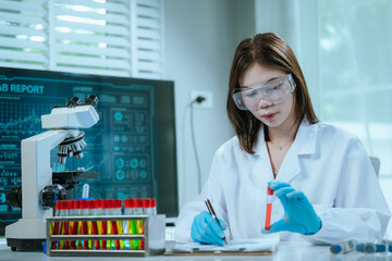 A scientist in a modern laboratory analyzes a blood sample using advanced biotechnology and equipment, conducting medical research for diagnostics, innovation, discovery, and healthcare development.