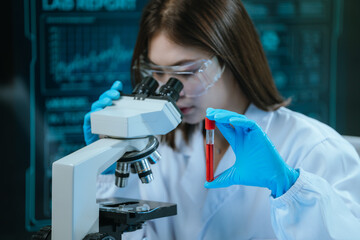A scientist in a modern laboratory analyzes a blood sample using advanced biotechnology and...