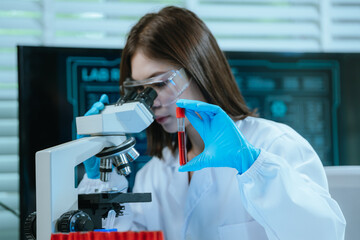 A scientist in a modern laboratory analyzes a blood sample using advanced biotechnology and...