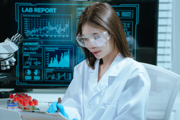 A scientist in a laboratory conducts a medical experiment with a red liquid in a test tube,...