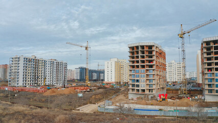 New residential buildings under construction in a growing urban area during overcast weather