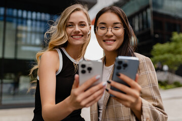 young pretty women walking outside in street doing business