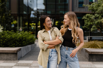 two young pretty women students in street
