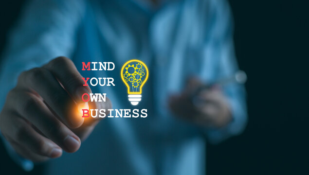 Businessman with MYOB Mind Your Own Business is shown using a text concept.