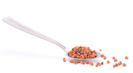Spoon with buckwheat isolated.