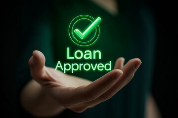 A glowing "Loan Approved" text and checkmark symbol hovering over an open palm, representing successful financial application, credit approval, mortgage, and banking concepts