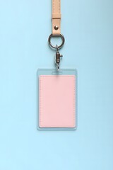 Blank Pink ID Card Holder with Lanyard on Blue Background
