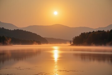Obraz premium Calm Sunrise Over Misty Lake Surrounded by Mountains and a Peaceful Landscape