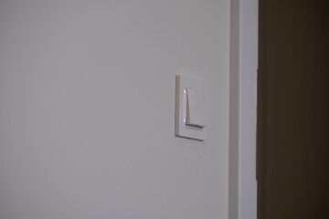 Minimal light switch on white wall