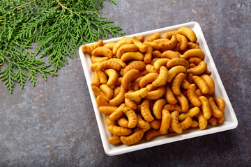 Indian savoury snack - cashew biscuits served in white ceramic plate.