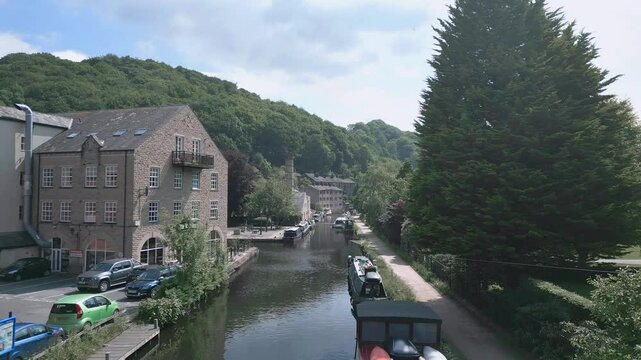Drone shot of the historic building overlooking River Calder on a sunny day in Mytholmroyd, England
