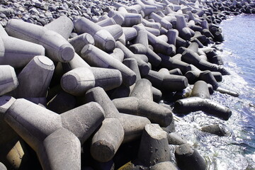 Tetrapods act as breakwaters against the strong waves of the Atlantic Ocean. Here in Funchal, the capital of the island of Madeira, Portugal.