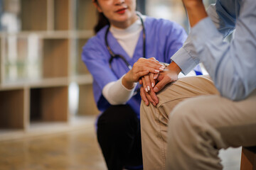 Female nurse hold her man patient's hand. Concept of giving Support. 
