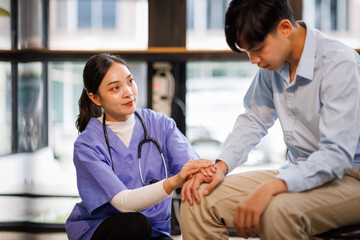 Female nurse hold her man patient's hand. Concept of giving Support. 
