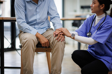 Help health or Doctor or nurse holding hands with patient zoom for support 
