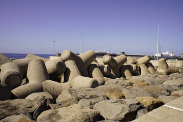 Fototapeta premium Tetrapods act as breakwaters against the strong waves of the Atlantic Ocean. Here in Funchal, the capital of the island of Madeira, Portugal.