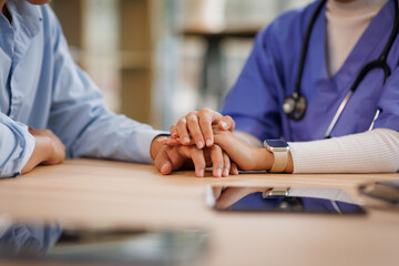Closeup, trust and holding hands for empathy in retirement, nurse and helping.Hands, caregiver and...