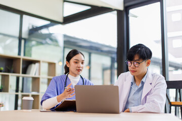 Office, laptop and doctors with nurse medical advice, meeting and discussion with planning, healthcare and insurance in office hospital

