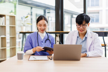 Obraz premium MIddle Asian doctor and nurse sharing information on patient case Planning, writing and healthcare team in office hospital. 