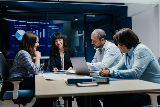 Business executives and assistants brainstorming investment risk evaluation in corporate boardroom