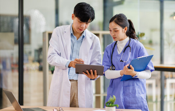 Attractive asian woman nurse and doctor working with smiling and freshness together to takecare ill old senior patient in Planning, writing and healthcare team in office hospital