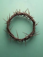 Fototapeta premium Crown of thorns on green background symbolizing sacrifice and faith.