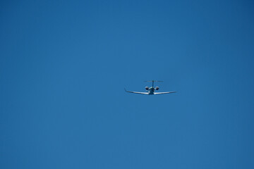 Airplane Takeoff and Climb Against Clear Blue Sky. Dynamic view of a jet aircraft ascending after takeoff.  Airplane taking off against blue sky