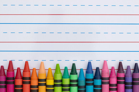 Crayons with ruled loose leaf notebook paper background - Powered by Adobe