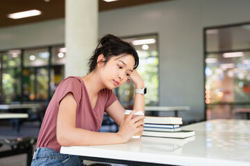 young student woman sitting at table relaxing and drinking coffee.