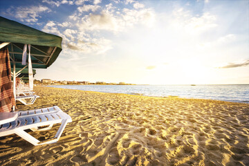 Sandy beach with sunbeds