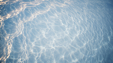 Close-up of light reflections on calm, clear blue water