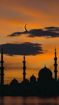 Mosque during Ramadan with a crescent moon and sunset sky.