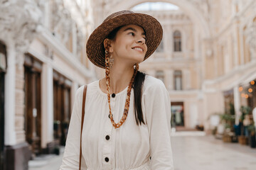 attractive woman walking in shopping street in Italy on vacation dressed in white summer fashion...