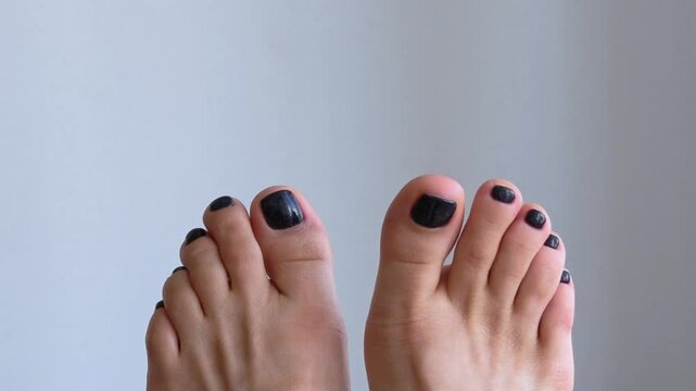 Female feet with pedicure on white background close-up.
