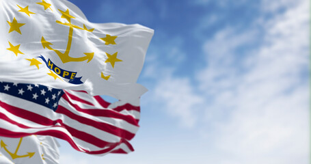 Rhode Island state flags waving with the american flag on a clear day
