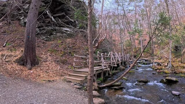 A wooden bridge spans a creek along one of the scenic trails in the Pocono region