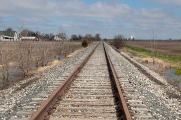 Fototapeta premium View of railroad tracks in the countryside. Path ahead or journey concept.