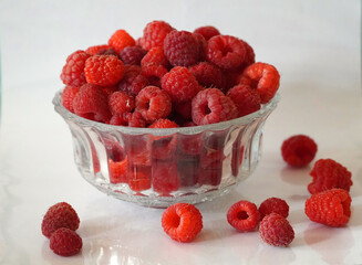 ripe red raspberry berry in glass bowl on table harvest agriculture background texture